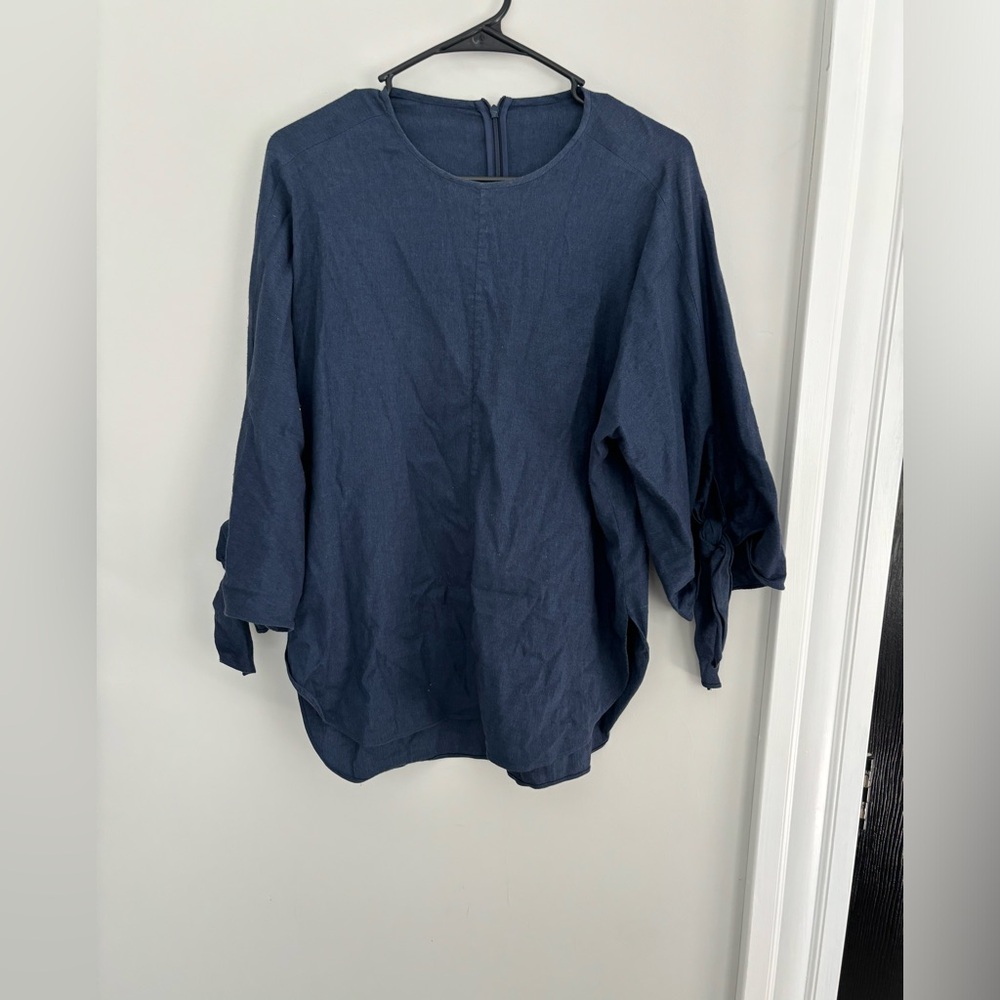Small cotton navy blouse with tie sleeve detail.
